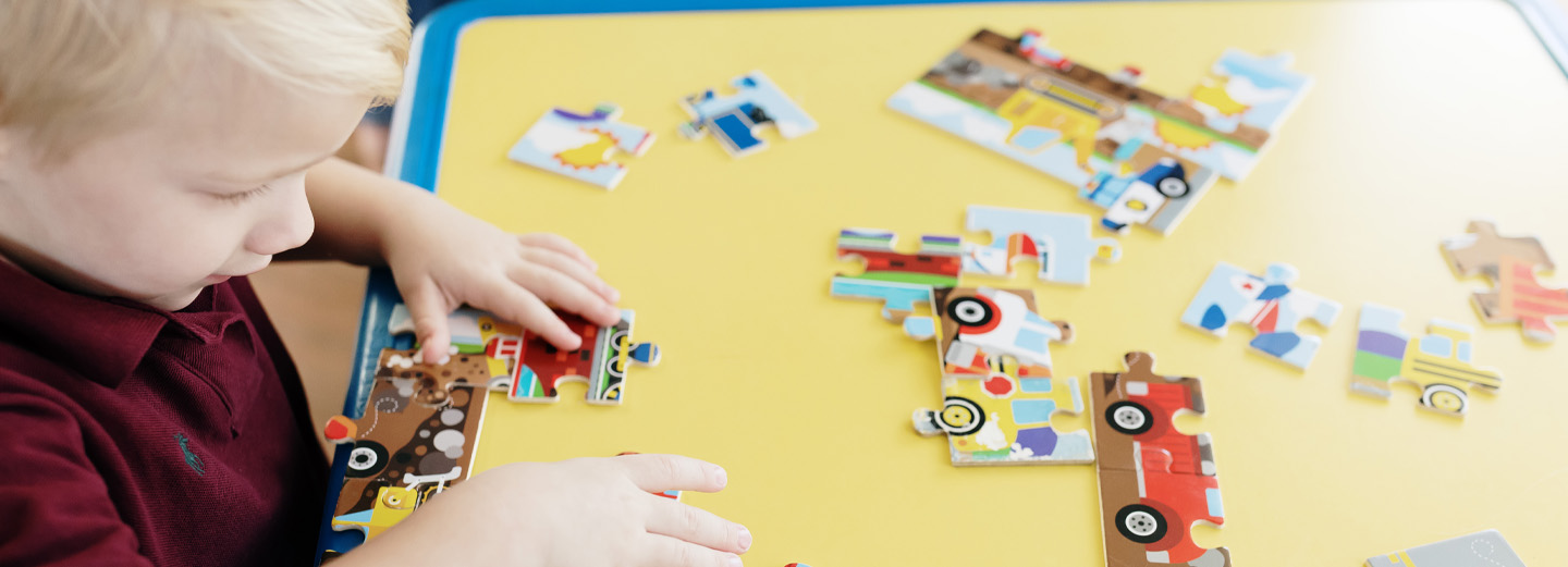 Child playing with puzzle at Childcare Center