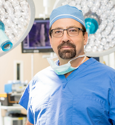 Doctor in surgical scrubs and cap in operating room