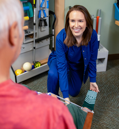 Physical therapist holding a patient's leg