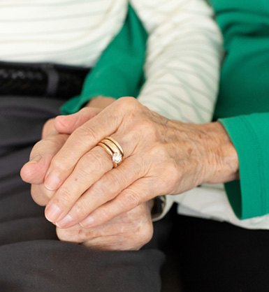 Photo of an older married couple holding hands