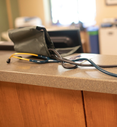 Stethoscope and blood pressure cuff sitting on counter