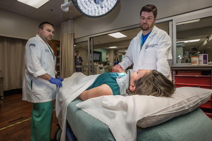 photo: trauma providers caring for patient on hospital bed