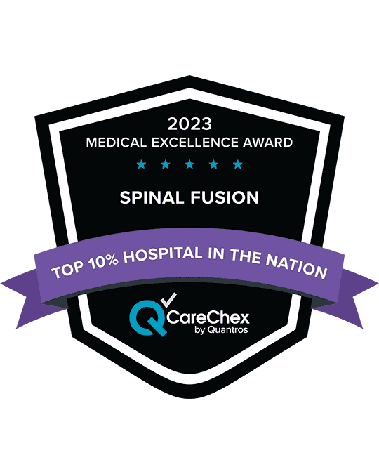 Awards badge for Top 10% Hospital in the Nation for Medical Excellence in Spinal Fusion - 2023 CareChex by Quantros
