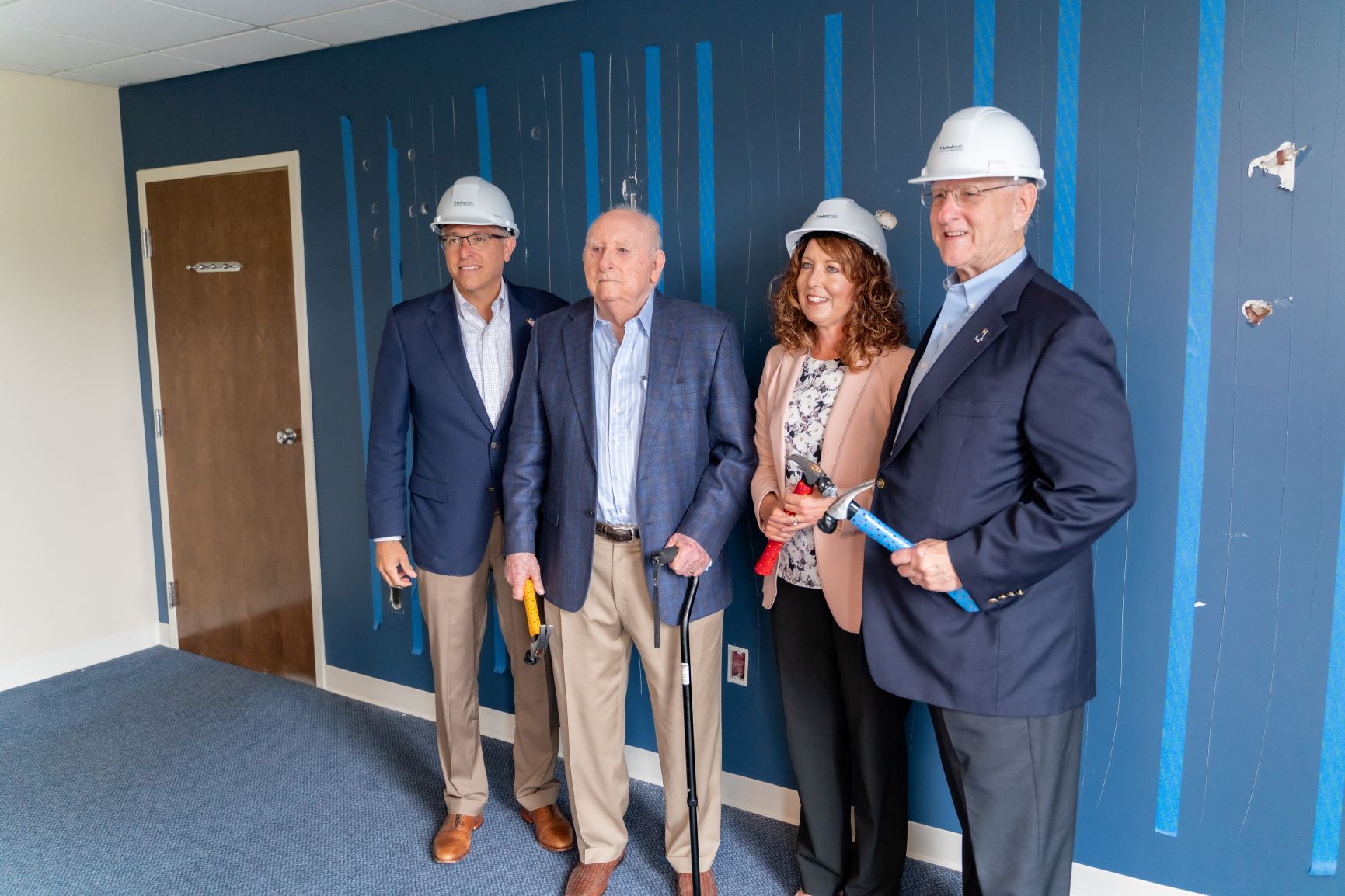 J.D. Nicewonder, Alan Levine, Lisa Carter and Scott Niswonger pose for photo with hammers to mark first phase of construction