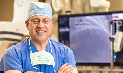 Ballad Health surgeon smiling in operating scrubs and cap