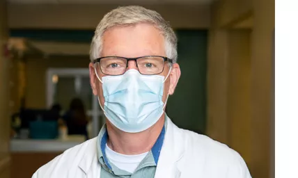 Doctor in glasses wearing surgical face mask