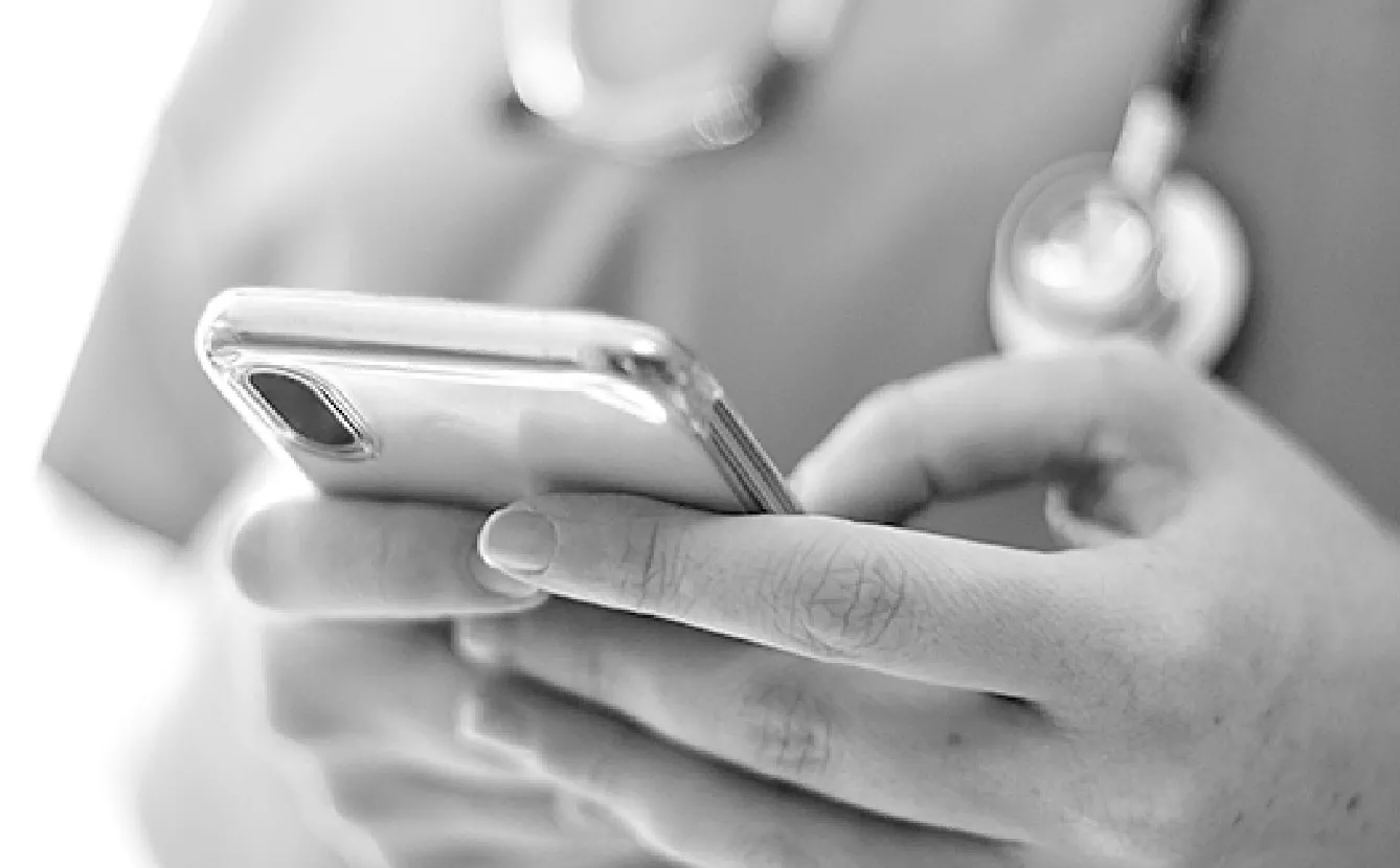 Black and white image of a person holding a cell phone