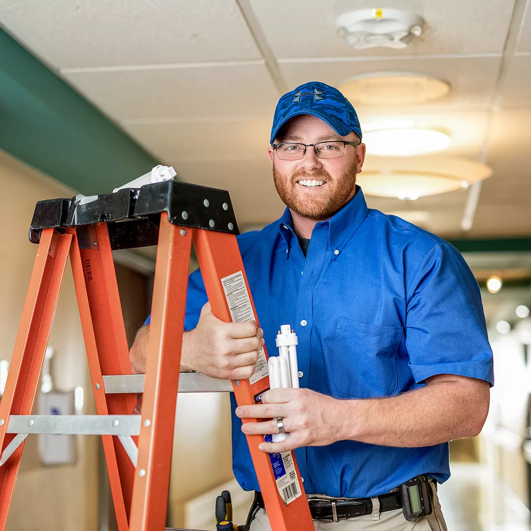 Electrician changing a lightbulb 