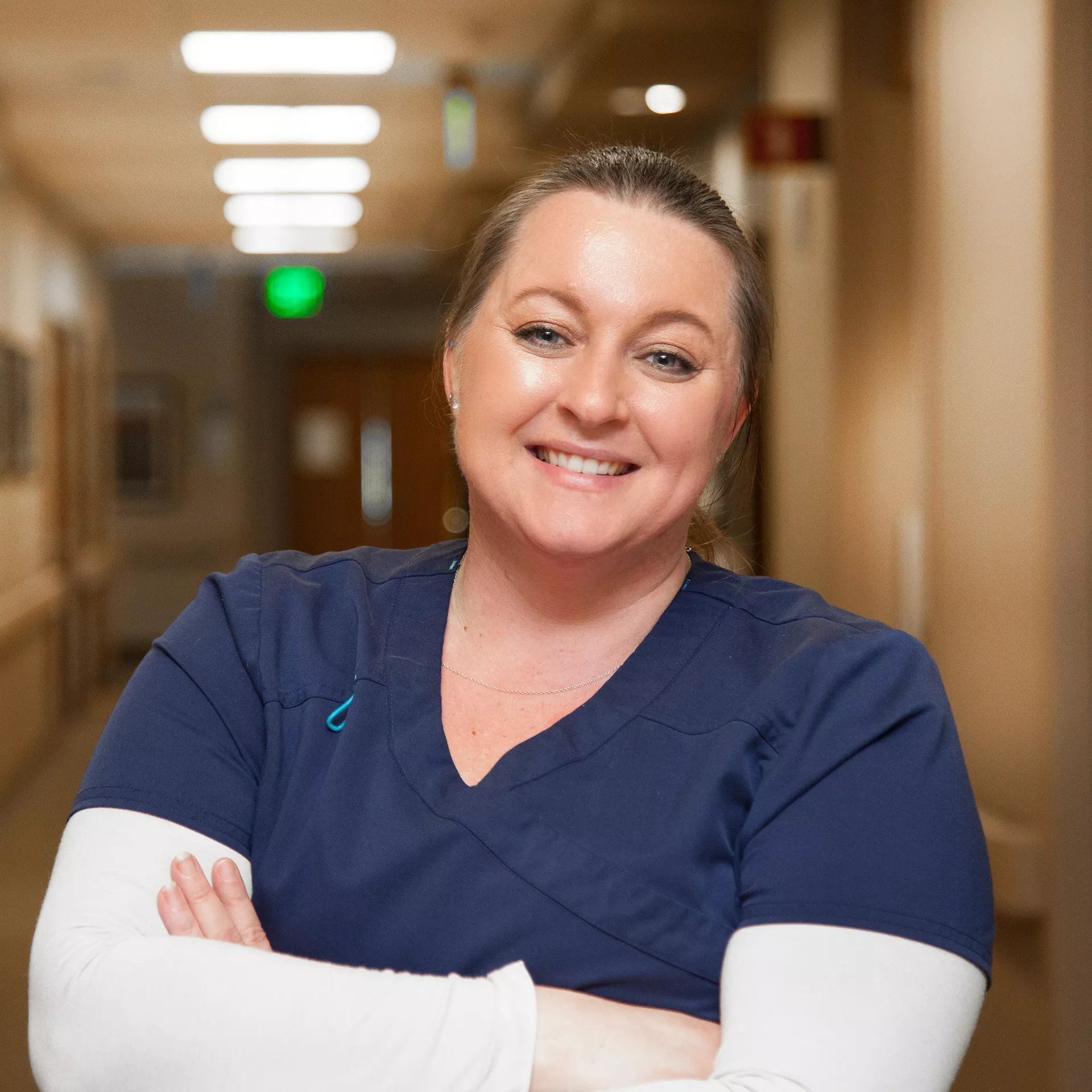 Certified Nurse Assistant in blue scrubs