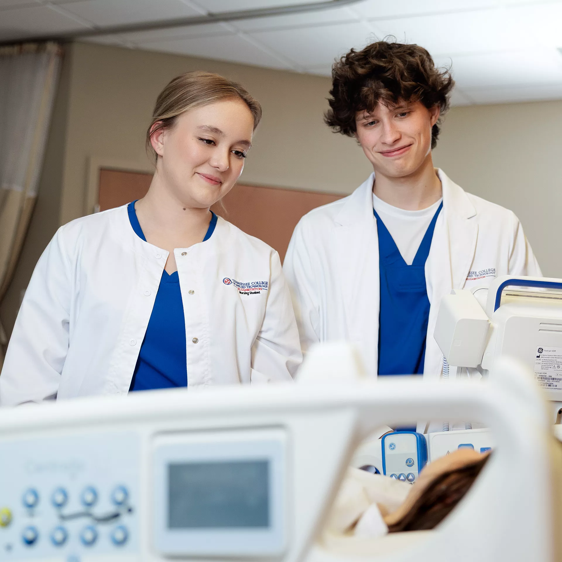 Nursing students by bedside