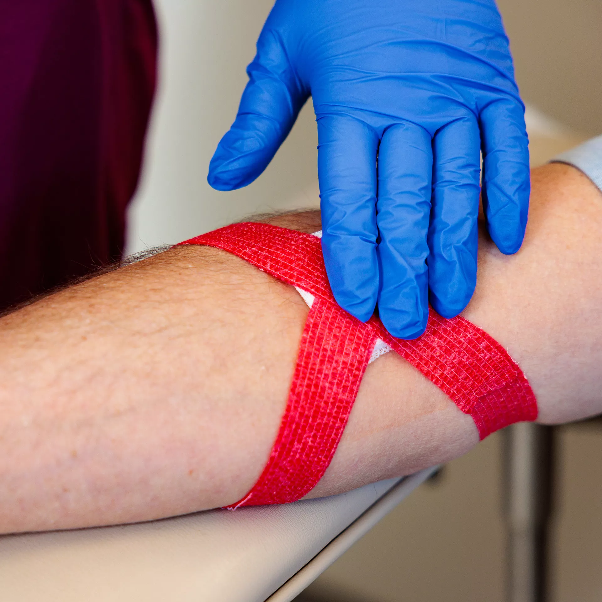Patient with bandage next to phlebotomist