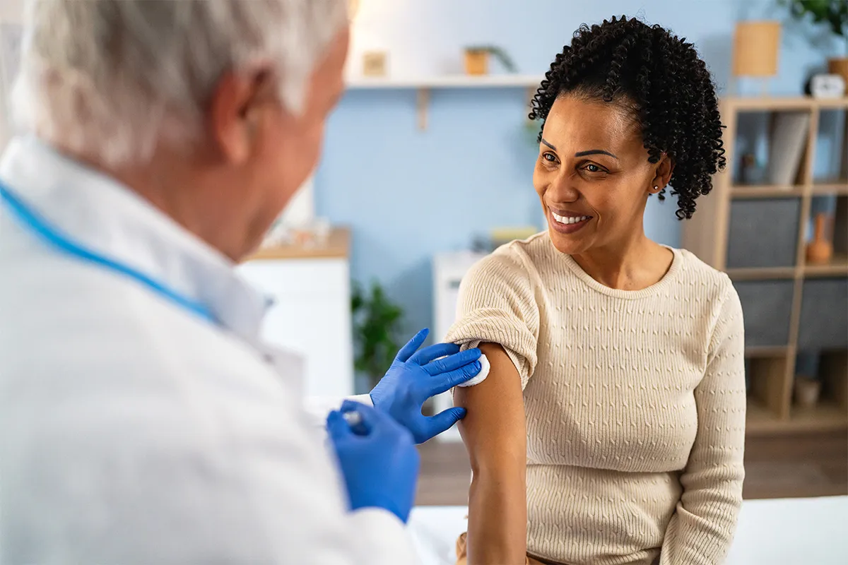 Photo of woman receiving immunization from a pharmacist