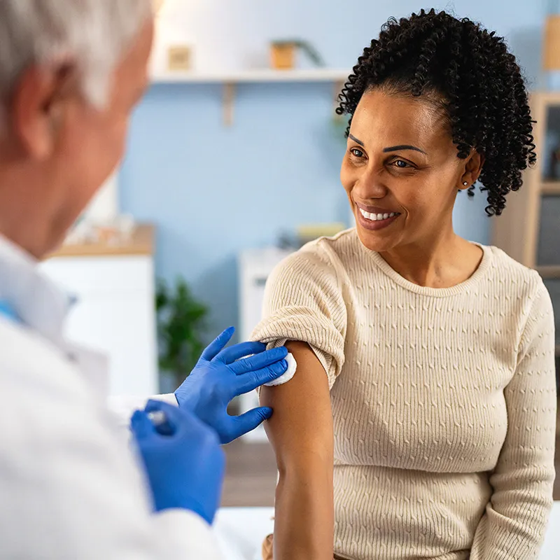 Photo of a doctor giving a woman a vaccine