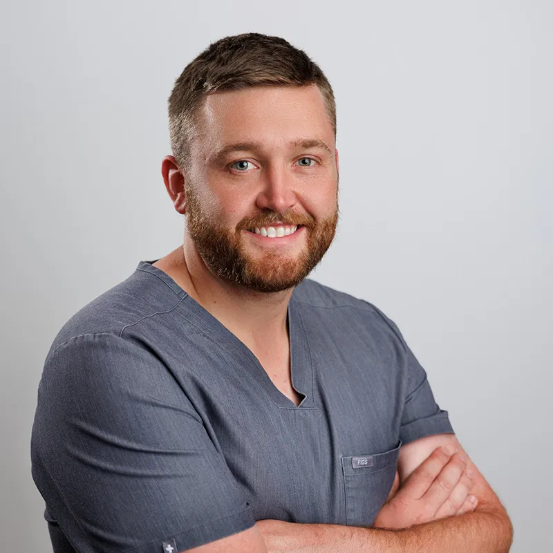 Photo of Austin Blackburn, RN in gray scrubs
