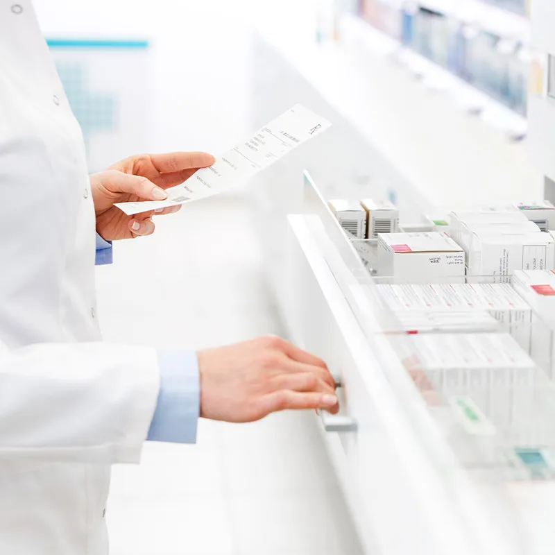 Photo of pharmacist looking through medication drawer