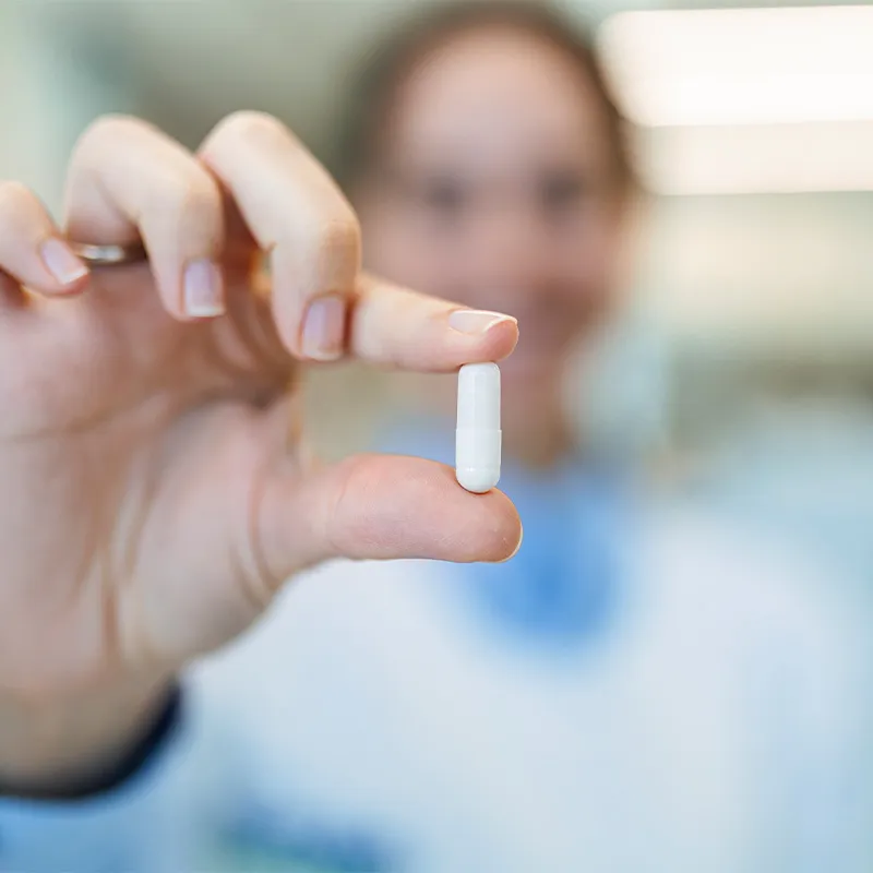 Photo of a pharmacist holding a pill