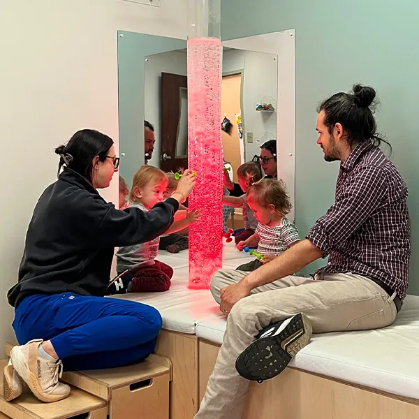 Physical therapist, pediatric patients, and a parent doing a sensory exercise