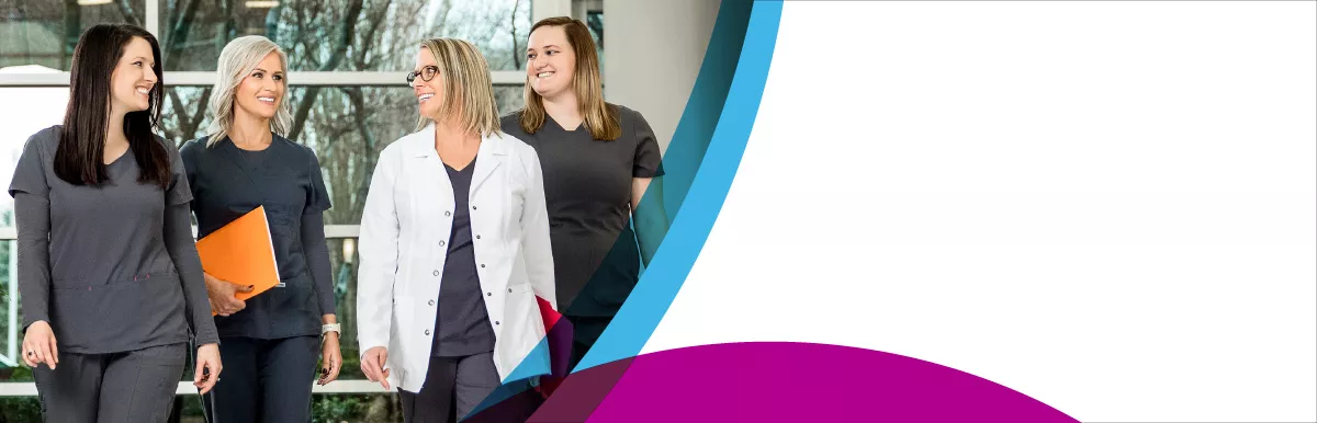 Four Ballad Health female nurses wearing gray scrubs walking